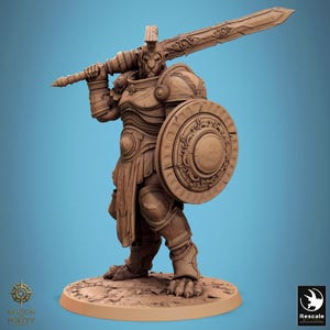 May include: A detailed brown figurine of a warrior in full armor, holding a large sword over his shoulder and a round shield. The warrior has a lion-like face and stands on a circular base. The figurine is intricately sculpted with fine details.