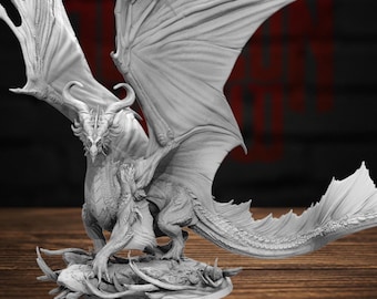 May include: A grey, unpainted dragon figurine featuring large, expansive wings, curved horns, and intricate scale detailing. The creature is depicted in a crouching stance on a rocky, textured base, showcasing sharp claws and a long, flowing tail.