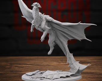 May include: A light gray unpainted resin miniature of a dragon in a dynamic flying pose. The creature features detailed scales, large outstretched wings, and a long tail that curls down to touch the circular base, which has a rocky texture.