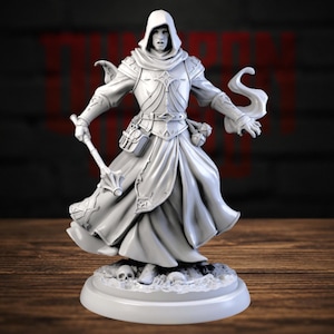 May include: A light gray miniature figurine of a hooded figure wearing ornate armor and robes. The figure holds a mace in the right hand, features a belt with pouches, and stands on a circular base decorated with small skulls and debris.