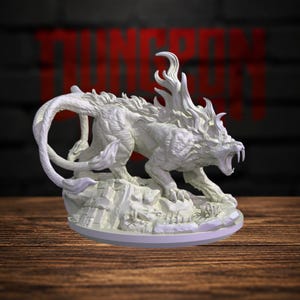May include: A white unpainted miniature figurine of a mythical feline creature with long fangs, a flowing mane, and two tails. The creature is posed in a dynamic stance on a rocky base with textured details, captured in a high-detail resin sculpt.