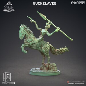May include: A green skeletal figure riding a skeletal horse, both with a green, fleshy appearance. The figure holds a spear in its right hand. The figure and horse are standing on a round base. The text "NUCKELAVEE" is at the top of the image.