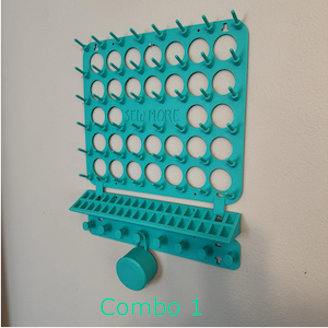 May include: A teal-colored sewing thread organizer with multiple pegs for holding spools. The organizer has the text "SEW MORE" and "Combo 1" printed on it. It is mounted on a white wall.