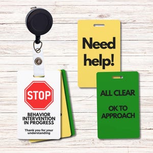 May include: Four different color-coded ID badges with text. The first badge is white with a red stop sign and the text "Behavior Intervention in Progress. Thank you for your understanding." The second badge is yellow with the text "Need help!" The third badge is green with the text "All Clear. Ok to Approach."