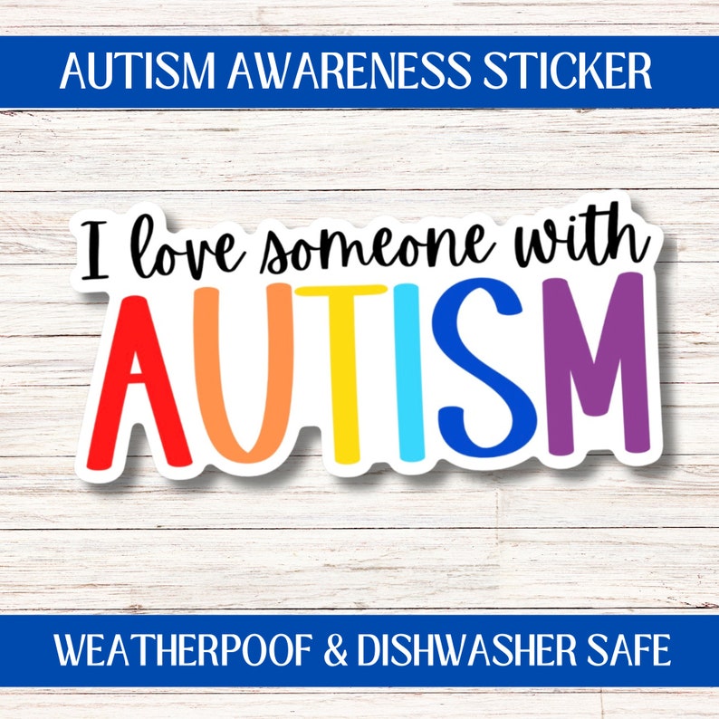 May include: A sticker with the text "I love someone with AUTISM" in rainbow colors. The sticker is on a white wood background. The text "AUTISM" is in large, bold letters. The sticker is weatherproof and dishwasher safe.