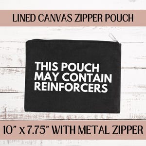 May include: Black canvas zipper pouch with white text that reads "This pouch may contain reinforcers". The pouch measures 10 inches by 7.75 inches and has a metal zipper.