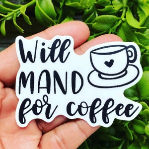 May include: White sticker with black text that reads "Will Mand for coffee" and a black outline of a coffee cup with a heart in the center.