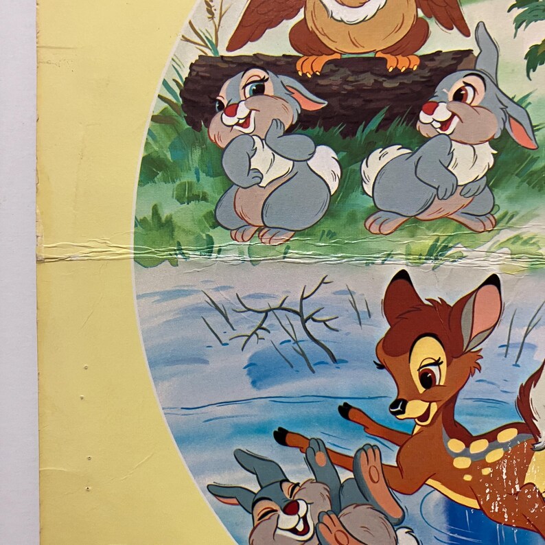 May include: A colorful illustration featuring characters from the animated film Bambi. The image includes a brown owl, gray rabbits, and a brown deer with white spots, set against a backdrop of a forest and water.
