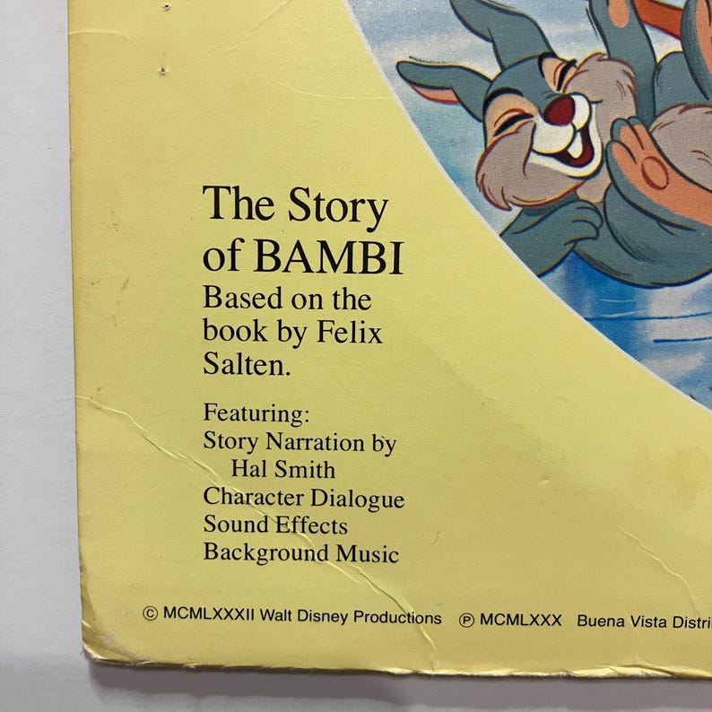May include: A vintage book cover for "The Story of Bambi" by Felix Salten. The cover features the title in bold black text, with additional text listing the book's features. A cartoon illustration of a smiling rabbit is visible in the upper right corner.
