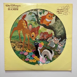 May include: A vintage Disney picture disc featuring Bambi and forest friends. The cover is yellow with the title "Walt Disney's Story and Songs from Bambi." The disc art shows Bambi, Thumper, Flower, and other characters in a colorful forest scene.