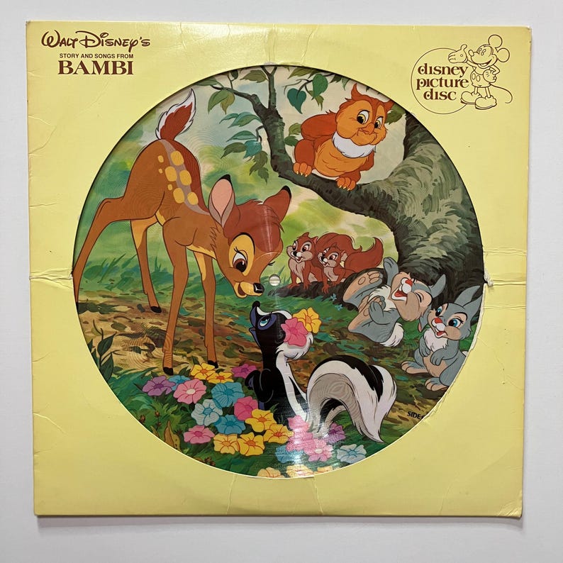 May include: A vintage Disney picture disc featuring Bambi and forest friends. The cover is yellow with the title "Walt Disney's Story and Songs from Bambi." The disc art shows Bambi, Thumper, Flower, and other characters in a colorful forest scene.