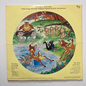 May include: A vintage vinyl record album cover for "The Story of Bambi." The cover features a circular illustration with forest animals, including deer, rabbits, an owl, and a skunk. The album title and song titles are also visible.
