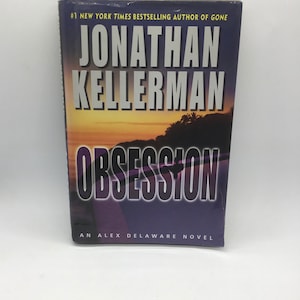 May include: A book cover with a purple background and the title "OBSESSION" in large white letters. The author's name, "JONATHAN KELLERMAN", is printed in white above the title. The book is described as "AN ALEX DELAWARE NOVEL" in white letters at the bottom of the cover.