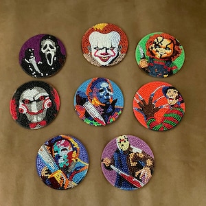 May include: A set of eight circular coasters featuring diamond art designs of various horror movie characters, including Ghostface, Pennywise, Chucky, Billy the Puppet, Michael Myers, Freddy Krueger, and Jason Voorhees, rendered in colorful beads.