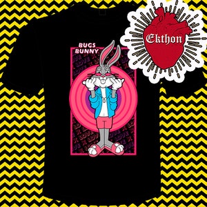 May include: Black t-shirt featuring a cartoon image of Bugs Bunny wearing a blue jacket and pink shorts. The image is surrounded by a pink circle with concentric circles and the text "BUGS BUNNY" in a white box above the image. The text "LOVE X LOVE" is repeated in a purple font around the image.