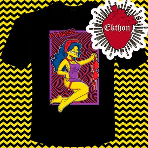 May include: Black t-shirt featuring a colourful illustration of Marge Simpson wearing a purple dress and red bra. The illustration is surrounded by a psychedelic pattern. The text "MARGE" is above the illustration. The text "Ekthon" is in a red heart shape in the top right corner.