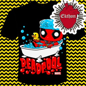 May include: Black t-shirt with a red and white cartoon Deadpool character taking a bath with a yellow rubber ducky. The text "DEADPOOL" is in red and white with a blue and white "MARVEL" logo below. The image also includes a red heart with the text "Ekthon" in white.