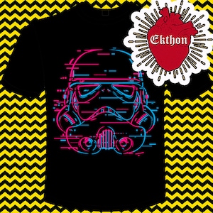 May include: A black t-shirt with a graphic of a Stormtrooper helmet in a glitched, pixelated style. The helmet is outlined in pink and blue. The text "Ekthon" is in a red heart shape with white rays.