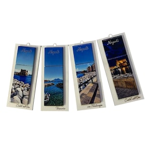 May include: Four rectangular magnets featuring photographic prints of Naples, Italy. Each magnet displays the text Napoli at the top and specific location names like Castel dell'Ovo, Vesuvio, and via Partenope at the bottom, showcasing coastal scenes.
