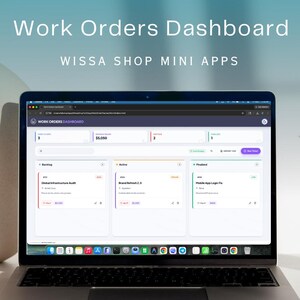 May include: A silver laptop displaying a "Work Orders Dashboard" interface. The screen shows data organized in panels with the text "Wissa Shop Mini Apps" above the screen. A paintbrush rests in a gold-colored holder.