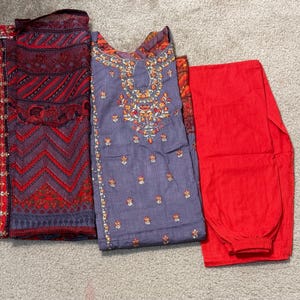 May include: A handmade wooden sign with the word "Welcome" in a playful font. It has a distressed white background and a dark brown frame, suitable for a front door or hallway. The sign is roughly 30 cm wide and 15 cm tall.