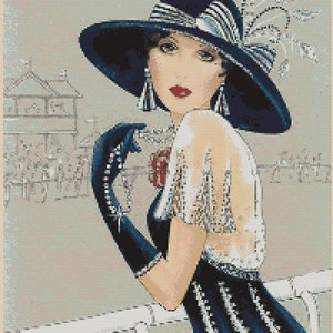 May include: A woman in a blue and white dress and a large black hat with a white feather. She is holding a glass of champagne and looking off to the side.