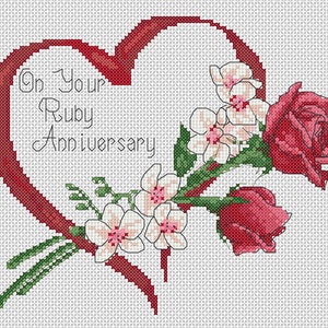 May include: A red heart-shaped ribbon with the text "On Your Ruby Anniversary" inside. A bouquet of white flowers and red roses are arranged next to the ribbon.