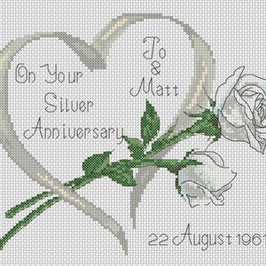 May include: A white cross-stitch design with a silver anniversary message, a single white rose, and the names "Jo & Matt" and the date "22 August 1961".