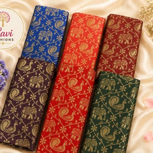 May include: Five rectangular fabric swatches featuring a repeating gold pattern of elephants and peacocks. The colors include royal blue, bright red, deep maroon, dark purple, and forest green. A circular logo with the text Lavi Fashions is visible.