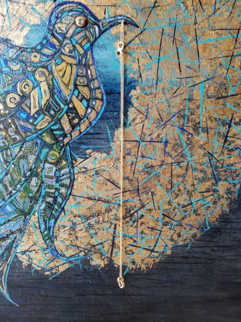 May include: Abstract painting of a bird with blue, gold, and teal geometric patterns. A delicate gold chain hangs from the bird's beak. The background features gold and teal brushstrokes on a dark blue canvas.