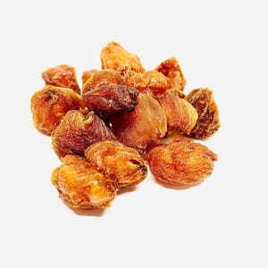 May include: A collection of dried fruit, with a variety of colours from golden brown to reddish-brown. The fruit pieces have a wrinkled texture and uneven shapes, giving a natural, unprocessed look. The background is plain white.