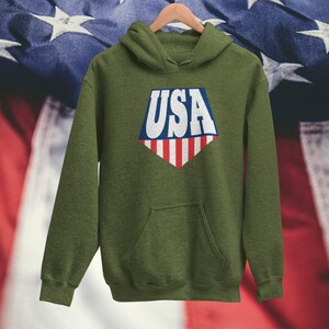 May include: A green hooded sweatshirt with a white "USA" graphic in a diamond shape with red and blue stripes.