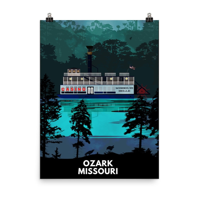 May include: A digital illustration of a white riverboat with the words "Casino" and "Missouri Belle" on the side. The boat is on a body of water with trees on either side. The text "Ozark Missouri" is at the bottom of the image.