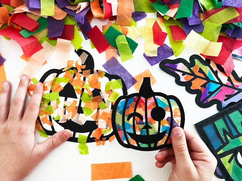 May include: Two black paper pumpkin cutouts with tissue paper glued inside. One pumpkin is filled with orange and green tissue paper, the other with multi-colored tissue paper.