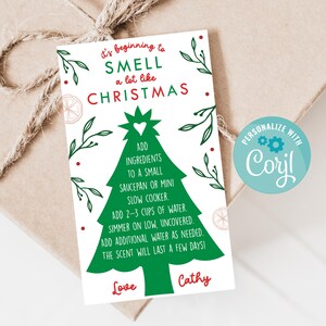 May include: A white Christmas card with green and red text, featuring a Christmas tree graphic and instructions for making a festive scent. The card includes the text "It's beginning to SMELL a lot like CHRISTMAS."