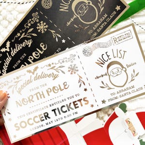 Pode incluir: Bilhetes de Natal dourados com o texto "Special Delivery From The North Pole" e "Nice List". Um bilhete &eacute; preto, o outro &eacute; branco. Os bilhetes s&atilde;o para "Soccer Tickets" em Londres.