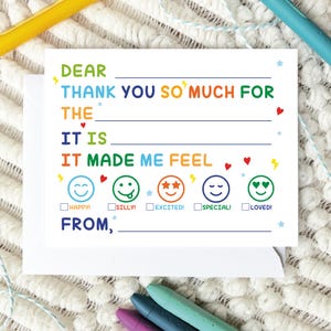 May include: A white fill-in-the-blank thank you card with colorful text and graphics. The card reads "Dear, Thank you so much for the, It is, It made me feel" with options for Happy, Silly, Excited, Special, and Loved. A white envelope is included.