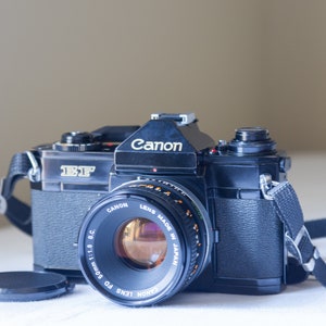 Canon EF SLR w/ FD 50mm f1.8: Vintage 35mm camera with fast prime lens and operating meter
