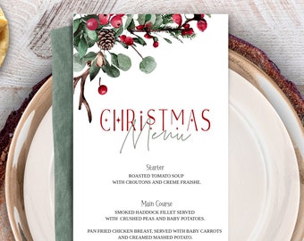 May include: A printable Christmas menu template with a watercolor illustration of red berries, pine cones, and eucalyptus leaves. The menu includes a starter, main course, and dessert.