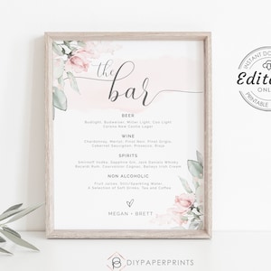 May include: Printable wedding bar sign with a pink and green floral design. The sign says "the bar" and lists the drinks available, including beer, wine, spirits, and non-alcoholic options. The sign also includes the names Megan and Brett.