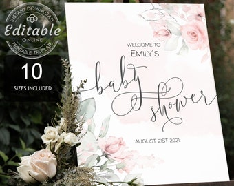 May include: A white sign with a watercolour floral design in pink and green. The sign says "Welcome to Emily's Baby Shower" and "August 21st 2021".
