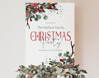 May include: A white sign with a red and green Christmas party invitation. The sign says "Welcome to The Wallace Family Christmas Party" and "Saturday 16th December". The sign is decorated with watercolor illustrations of pine branches, berries, and pine cones.