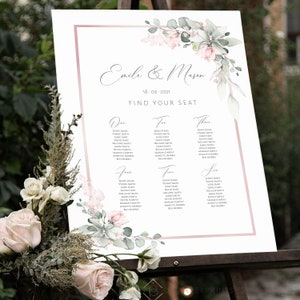 May include: A wedding seating chart with a pink and green floral design. The chart is titled "Emile & Masen" and lists guest names under the headings "One", "Two", "Three", "Four", "Five", and "Six".