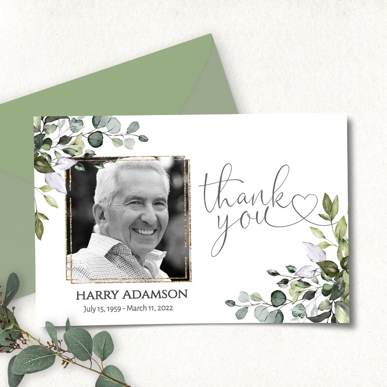May include: Thank you card with a black and white photo of a man in a gold frame surrounded by green and white watercolor leaves. The text "Thank you" is written in cursive with a heart symbol. The text "HARRY ADAMSON July 15, 1959 - March 11, 2022" is printed below the photo.