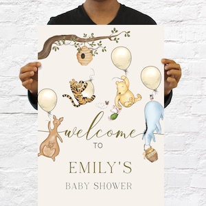 May include: A baby shower sign with illustrations of Winnie the Pooh characters, balloons, and a tree branch. The sign reads "Welcome to Emily's Baby Shower". The design includes a kangaroo, Tigger, Piglet, Eeyore, and Pooh Bear.