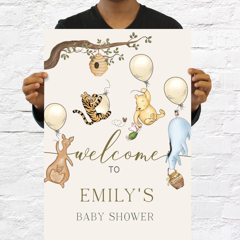 May include: A baby shower sign with illustrations of Winnie the Pooh characters, balloons, and a tree branch. The sign reads "Welcome to Emily's Baby Shower". The design includes a kangaroo, Tigger, Piglet, Eeyore, and Pooh Bear.