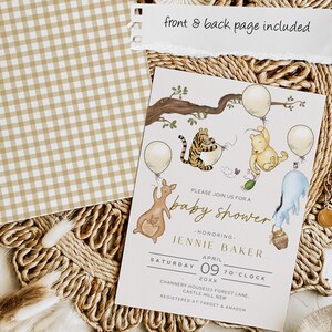 May include: Baby shower invitation with Winnie the Pooh characters, balloons, and a kangaroo. The invitation is cream-colored with gold text and illustrations. A separate tan and white gingham patterned card is also included.