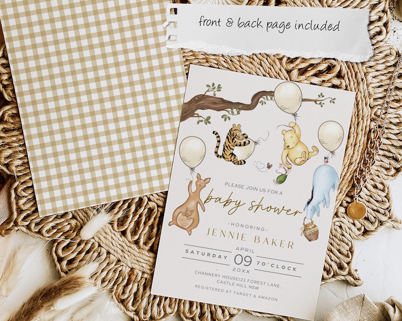 May include: Baby shower invitation with Winnie the Pooh characters, balloons, and a kangaroo. The invitation is cream-colored with gold text and illustrations. A separate tan and white gingham patterned card is also included.