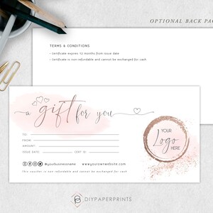 May include: A pink and white watercolor gift certificate template with the text "a gift for you" in cursive. The template includes fields for "To", "From", "Amount", "Issue Date", and "Cert ID". The bottom of the template includes social media icons, a business name, a website address, and the text "this voucher is non refundable and cannot be exchanged for cash". The template also includes a circle with the text "YOUR Logo HERE" in a gold glitter design.