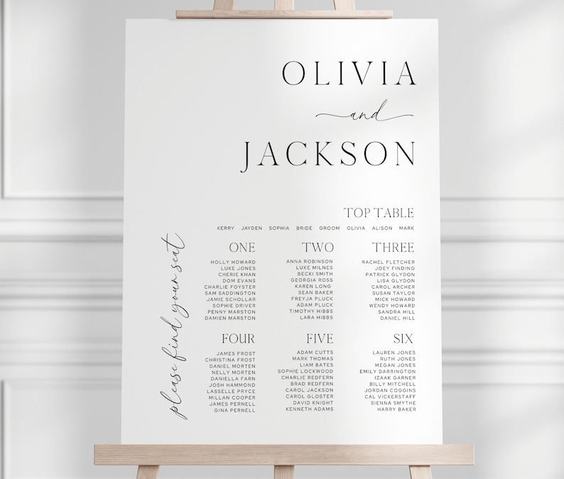 May include: A white wedding seating chart on an easel. The names "Olivia and Jackson" are at the top, with guest names organized by table number below. The words "please find your seat" are written on the left side.